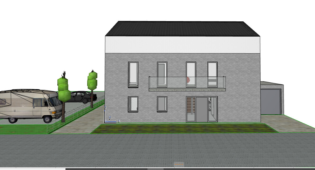 Two-story gray brick house with balcony, garage on right, caravan on left.