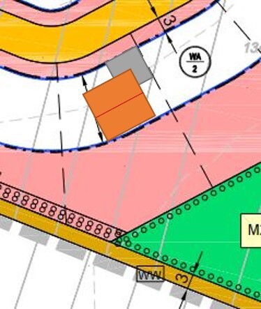 Site plan of a building plot with colored zones and building footprint