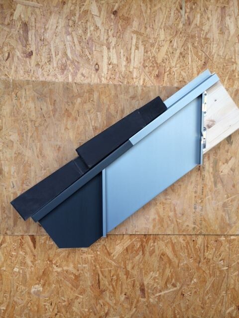 Metal profile attached to OSB board on wooden support.