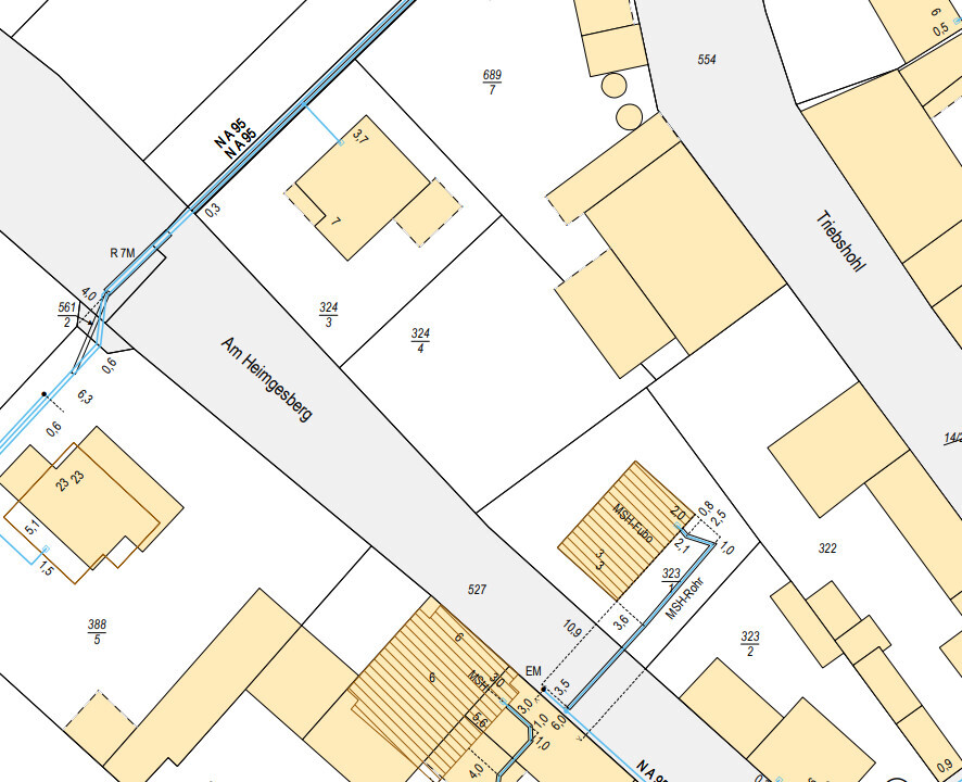 Site plan of a building plot with streets, buildings, and property boundaries.