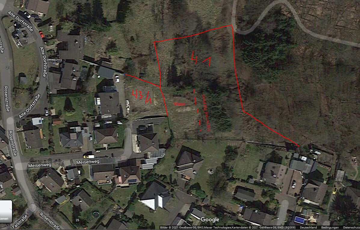 Aerial view of a residential area with red property boundary lines and street names