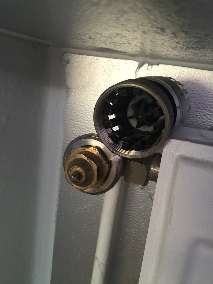 Close-up of a heating valve connection on the radiator.