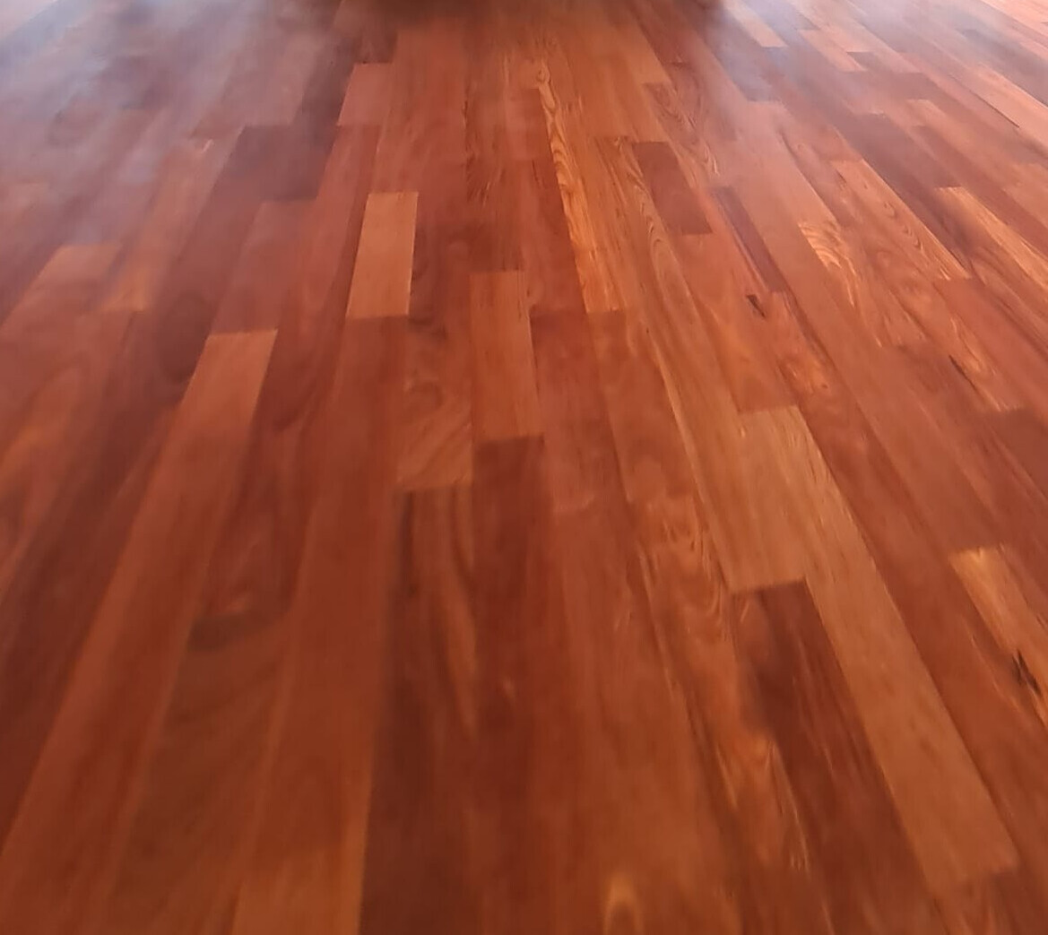 Wood floor with brown wooden boards in a parquet pattern, view of the floor.