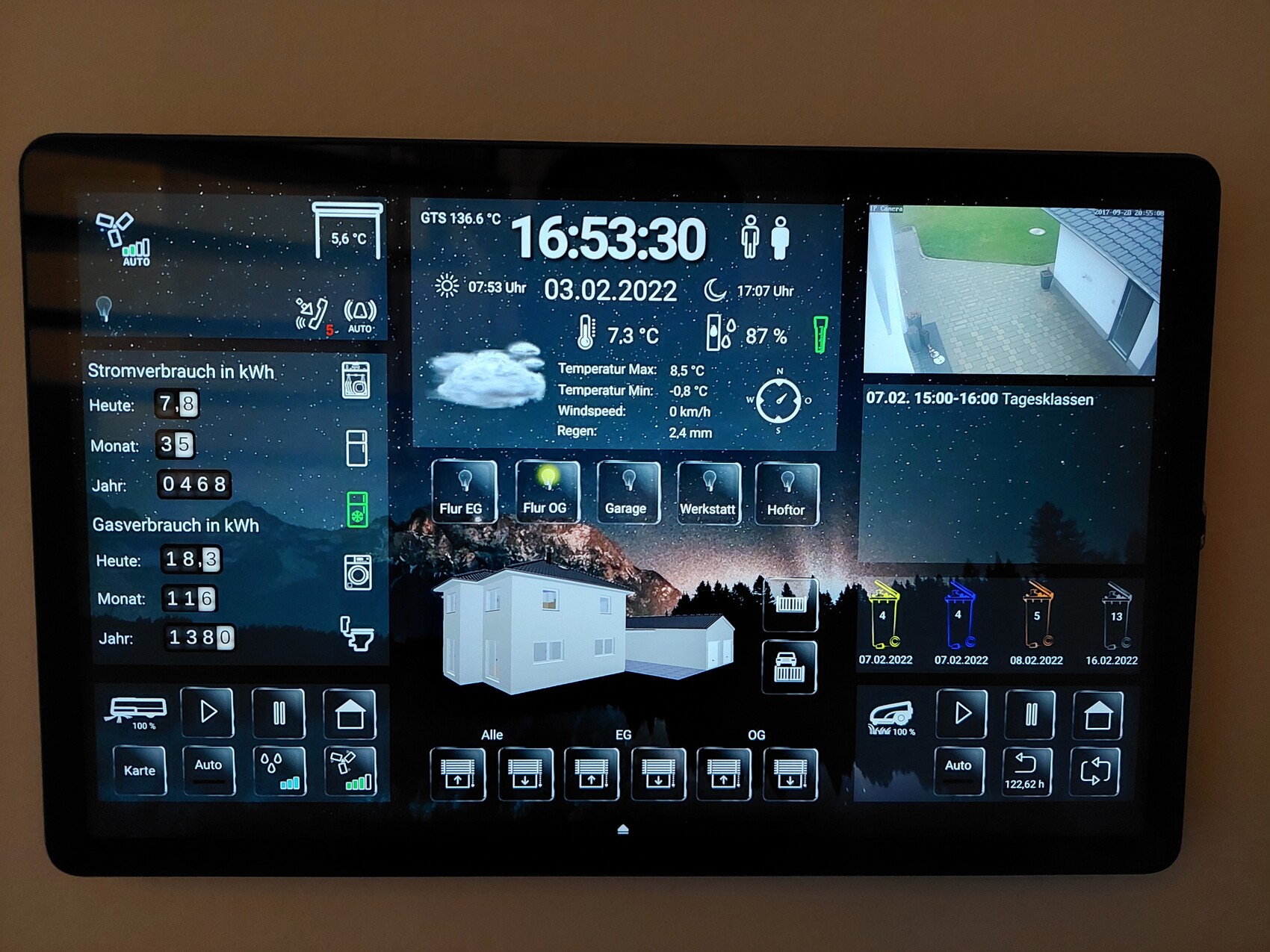 Tablet display showing home automation, energy data, weather information, and 3D house model