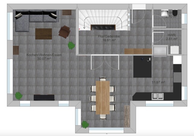 Open floor plan: kitchen/living/dining, dining table in the center, sofa on the left, staircase central.