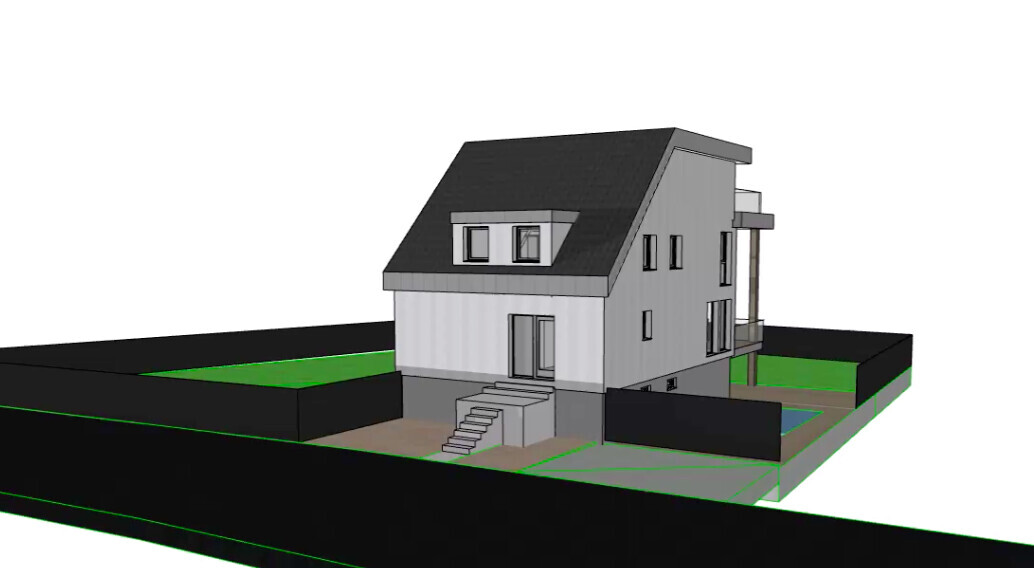 Modern two-story house with dark pitched roof, stairs to entrance and fenced garden.