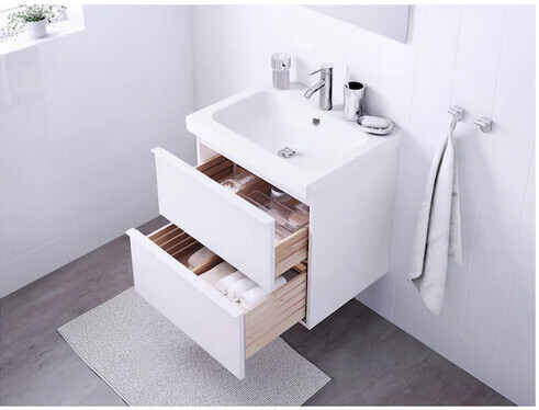 White washbasin with open drawers, towel rack, and modern faucet.