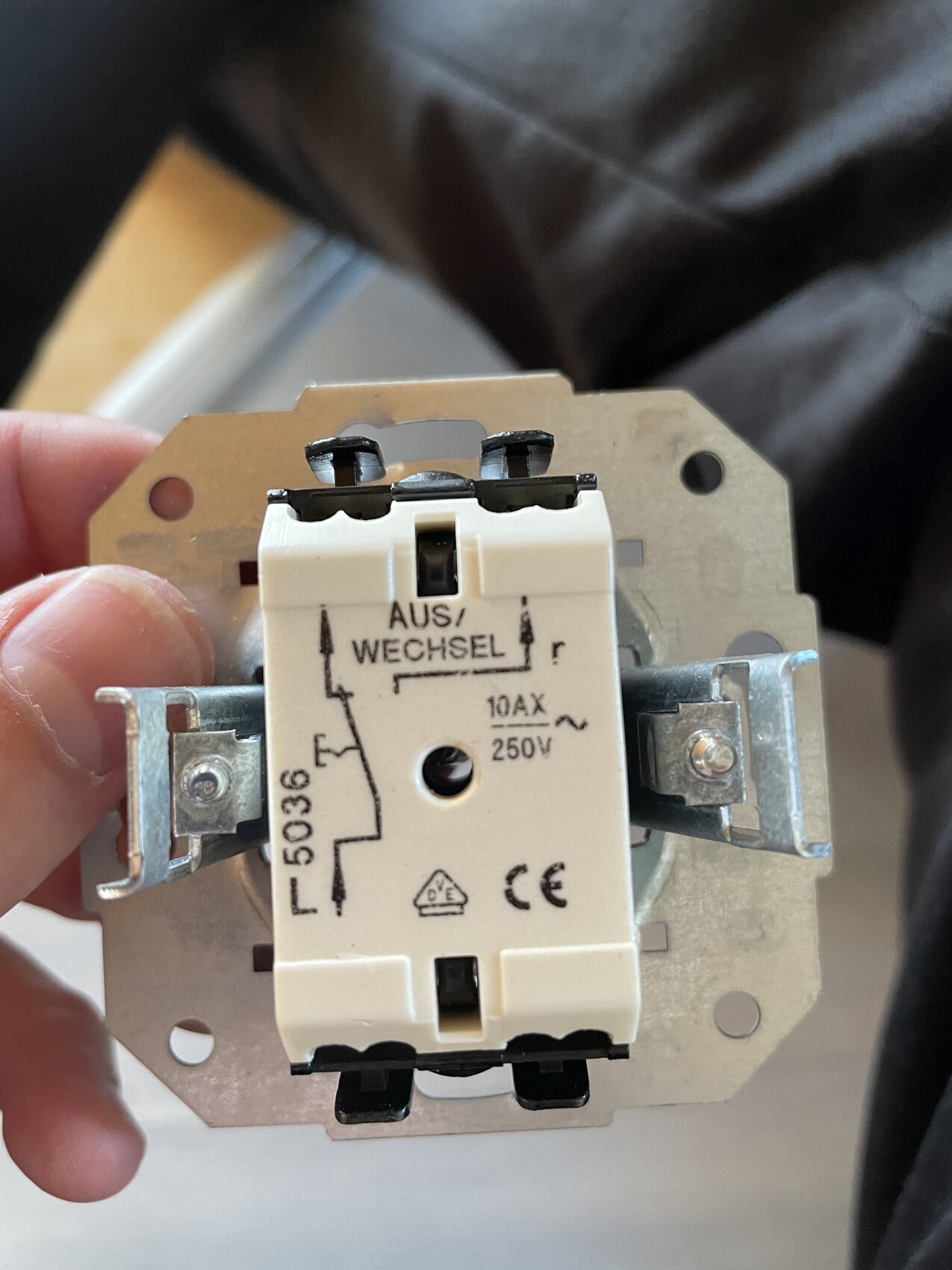 Close-up of a two-way switch (OFF/CHANGE) with metal frame