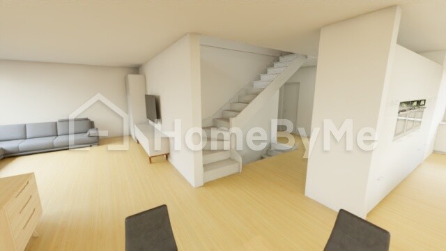 Bright open living space with sofa on the left, staircase in the middle, wooden floor and windows on the right.