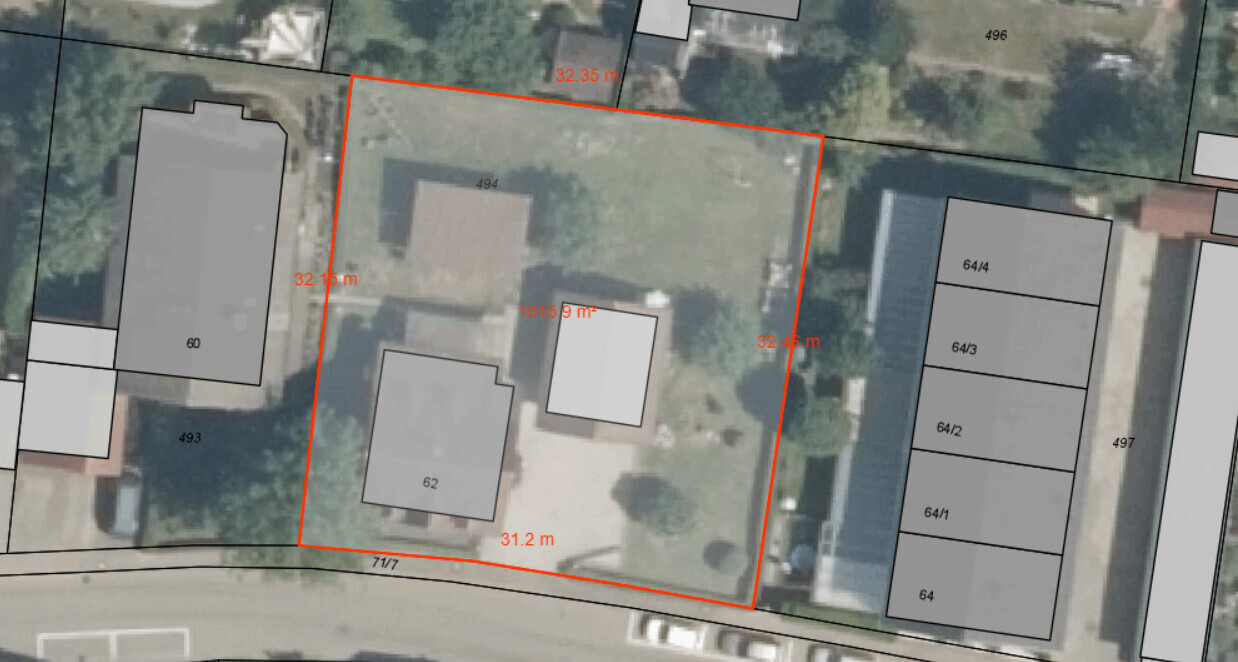 Aerial view of a property marked with a red boundary and surrounding buildings