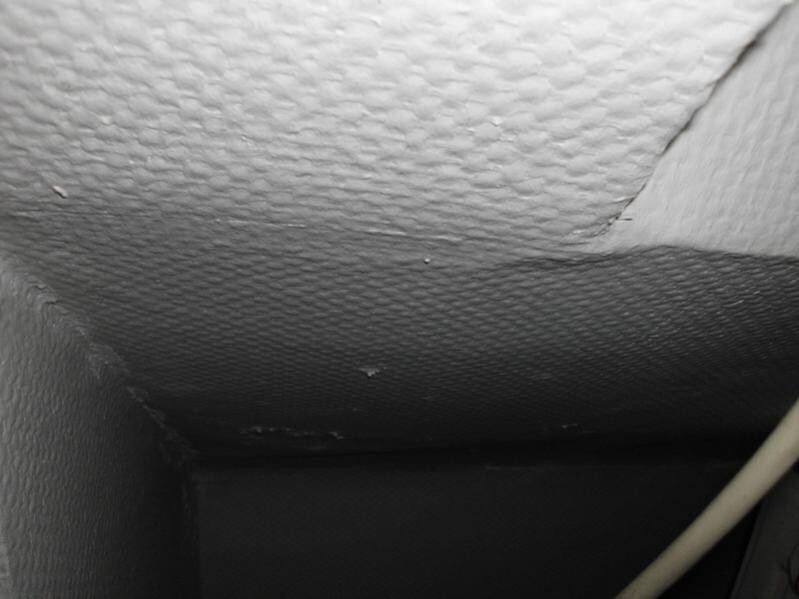 Rough-textured unfinished ceiling indoors, visible cables
