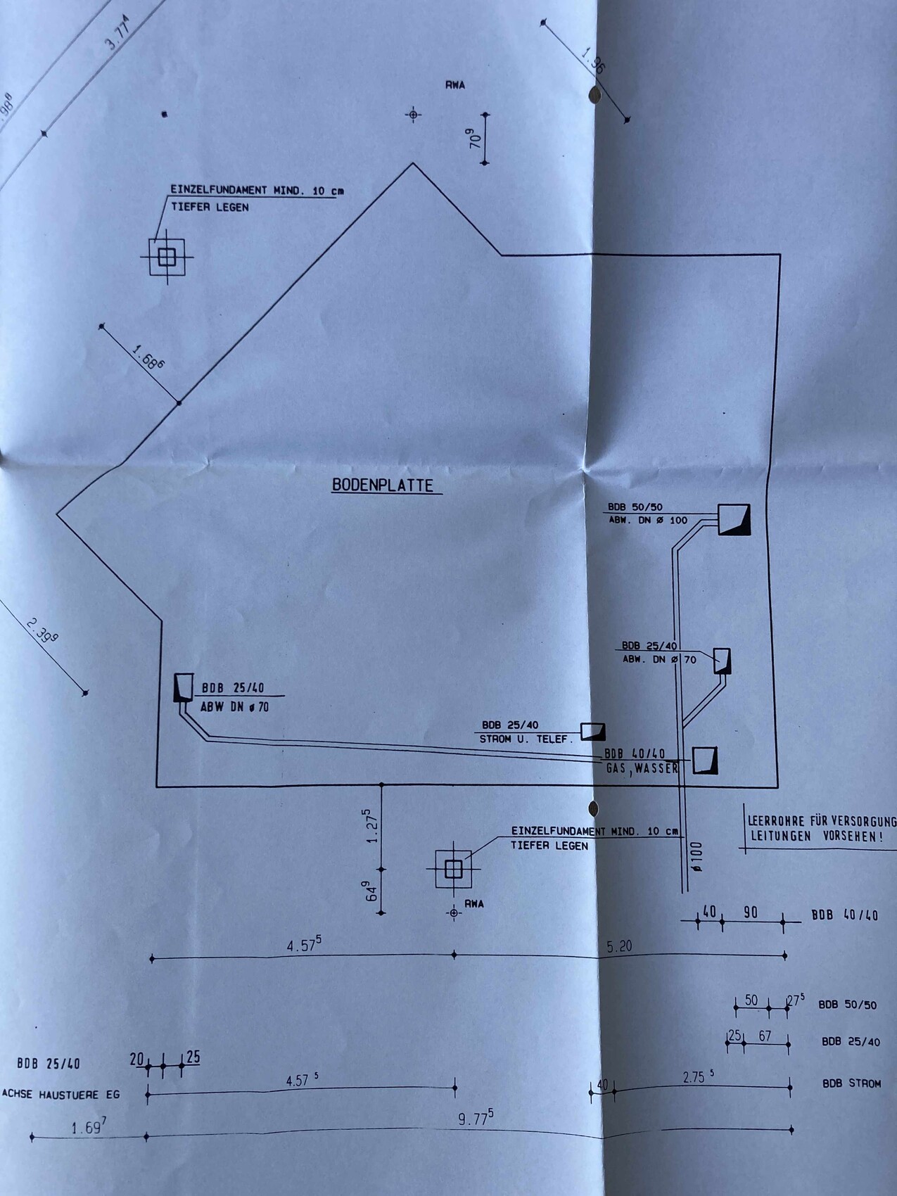 Foundation and floor slab drawing with dimensions, pipes and depth details.