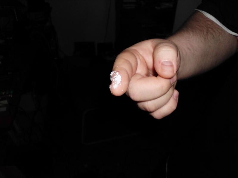 Close-up of a hand with white powder on the finger