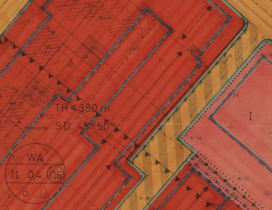 Technical map section with red building structures, blue contours and arrows.