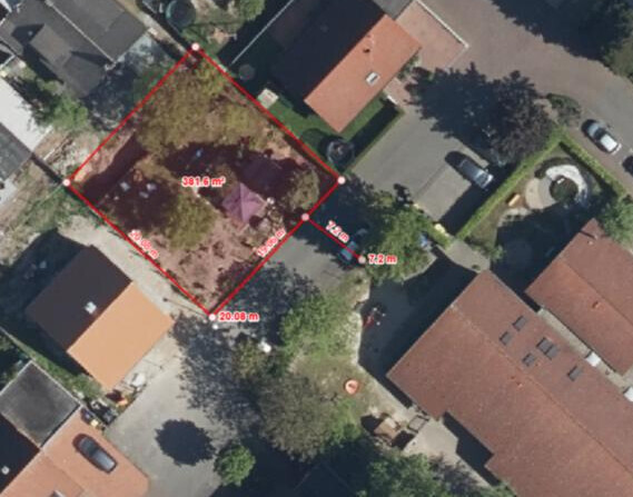Aerial view of a residential area with red property boundary and dimensions in meters