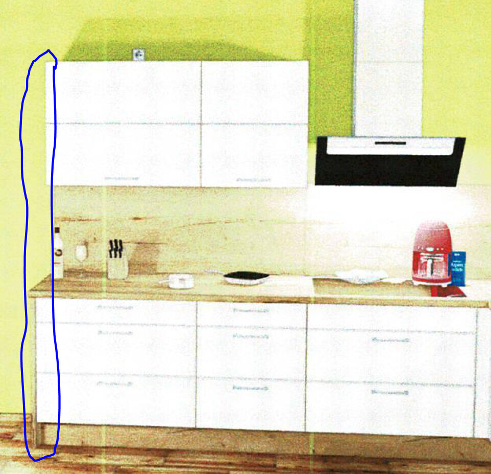 Kitchen with light green wall, white wall cabinets, wooden countertop, range hood, and red bottle.
