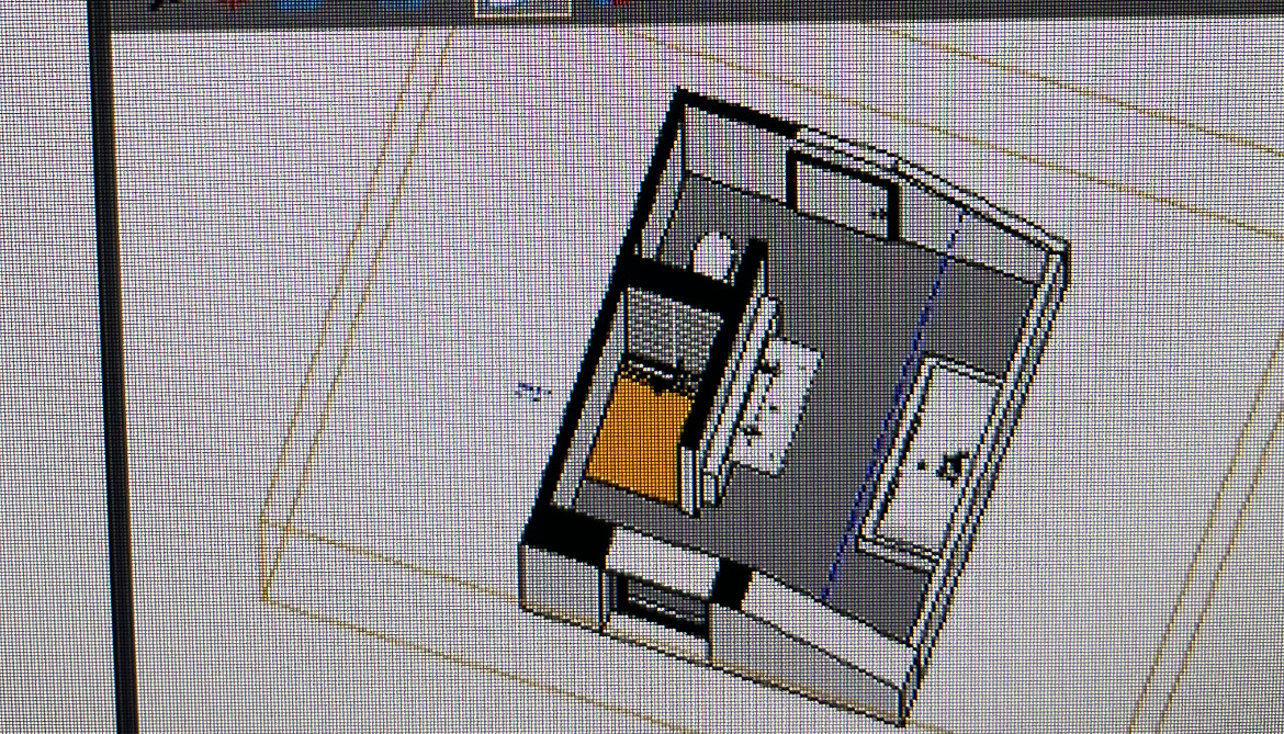 Isometric top view of a small room: bed with orange cover, desk, and bathroom area.
