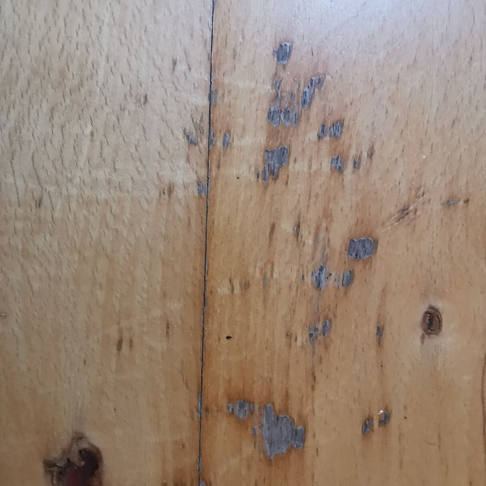 Wood planks with chipping paint, visible grain and knots
