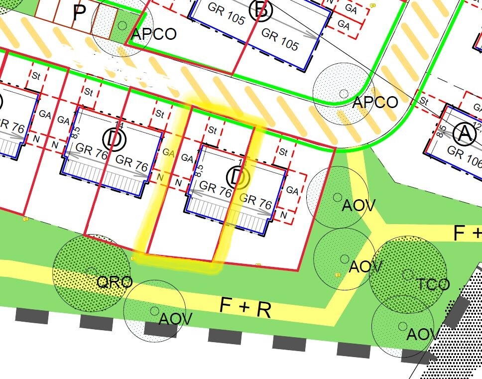 Site plan of a building area with buildings, roads and green spaces, color marked.