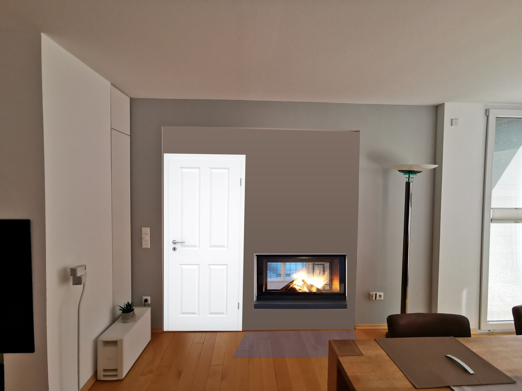Bright living room, fireplace burning, white door on the left, floor lamp on the right, dining table.