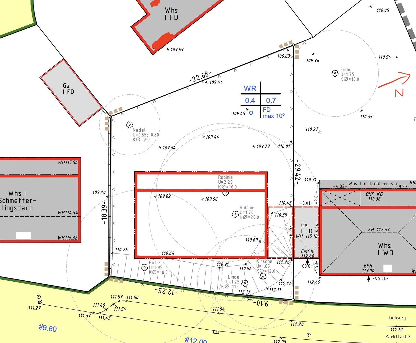 Site plan of a building plot with buildings, paths, and north arrow.