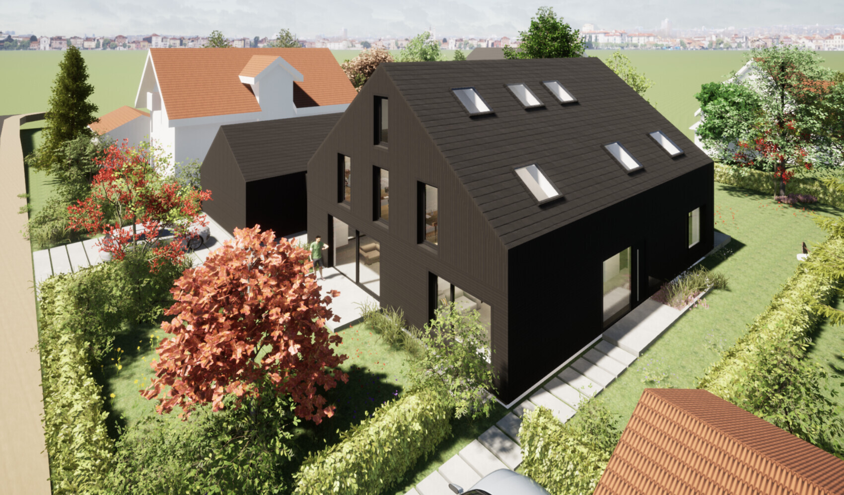 Modern black residential buildings with pitched roofs, roof windows, garden, and person at the entrance