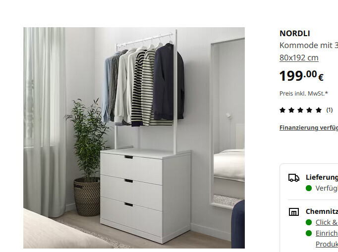 White clothes rail with hanging clothes, next to dresser, plant, and mirror in bedroom.