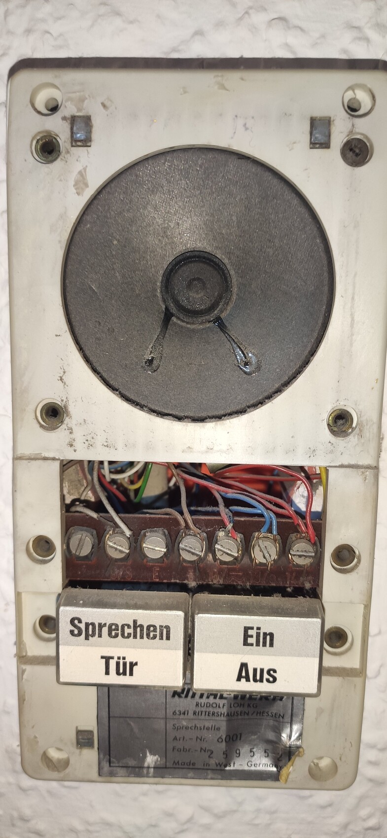 Old wall-mounted intercom system with speaker, cables, and two buttons: Talk/Door and On/Off.