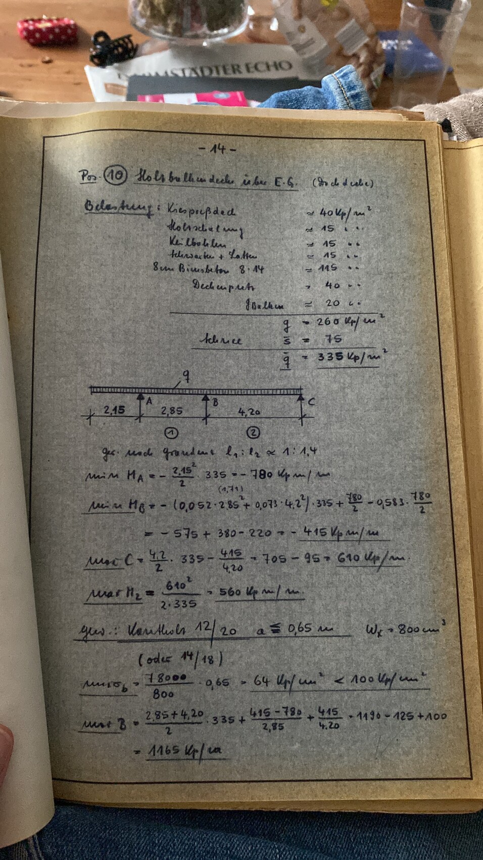 Handwritten calculations of a beam with A, B, C on a notepad.