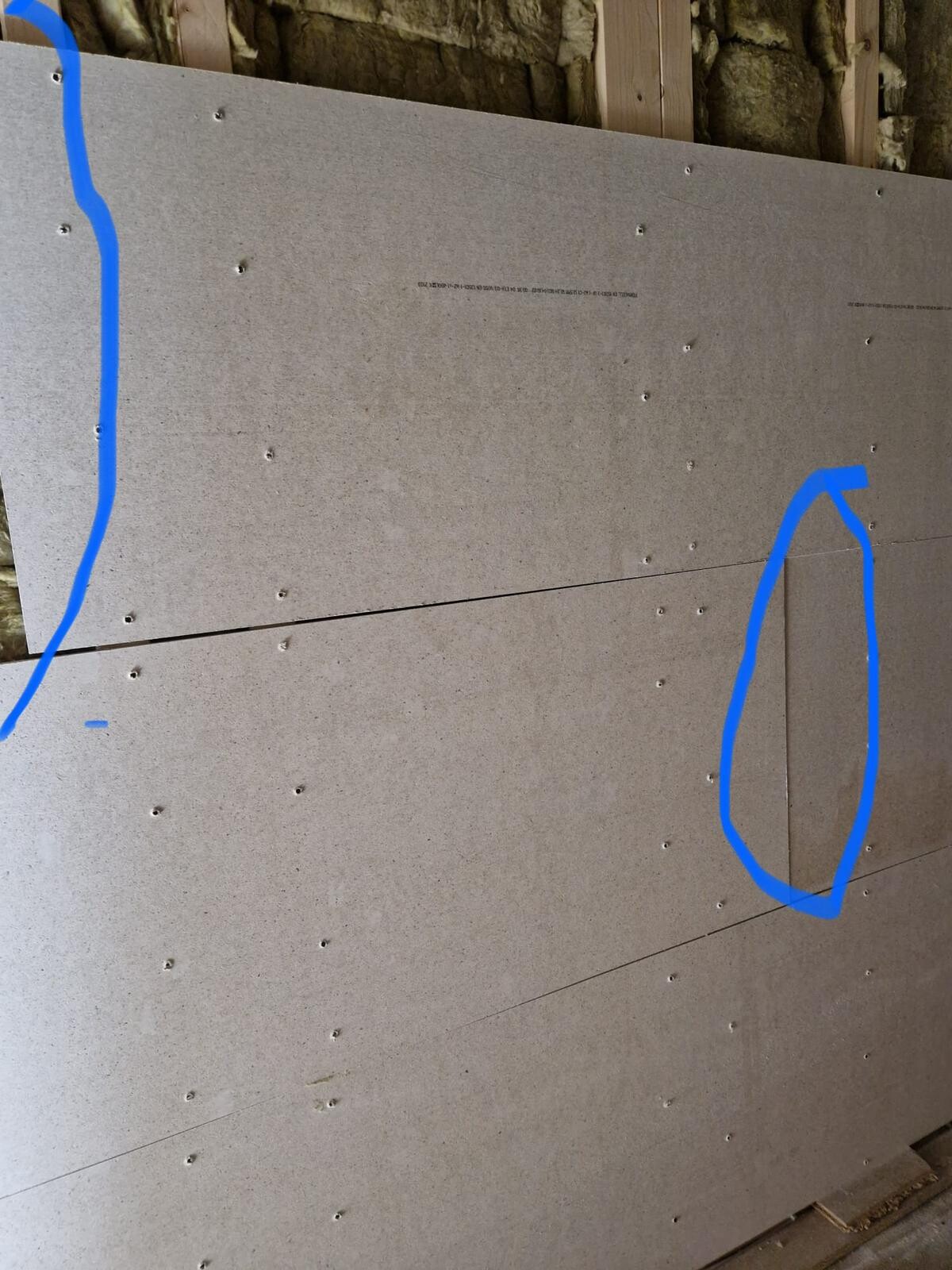 Large grey drywall panel (gypsum board) with screws, joints, wooden frame.