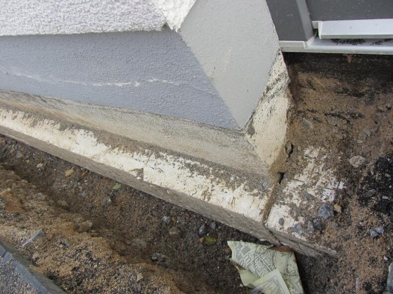 Foundation edge of construction site with soil and visible building materials