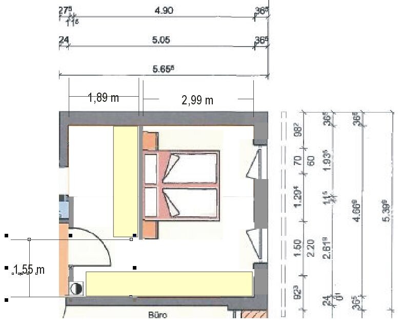 Floor plan of a small room with a double bed and office area.