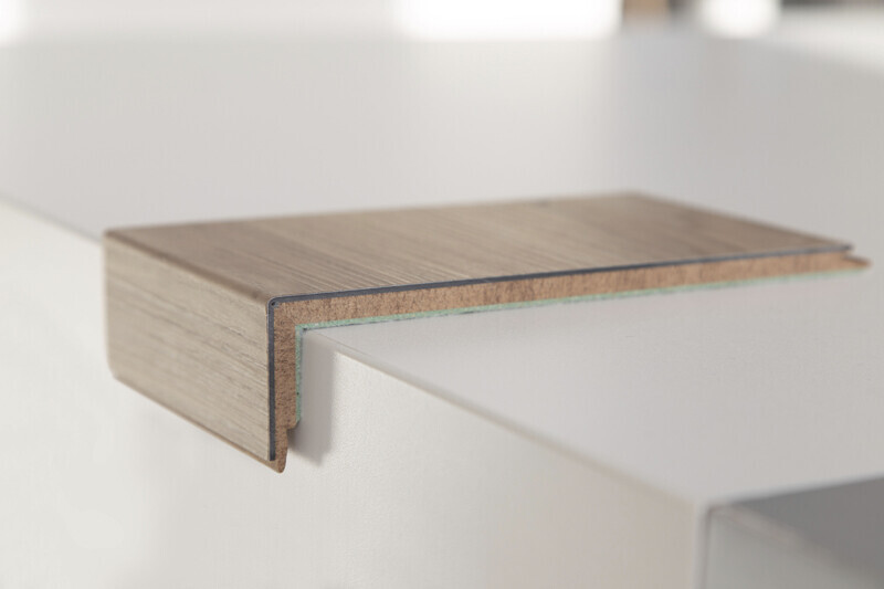 Close-up of a wood-look edge band on a white countertop