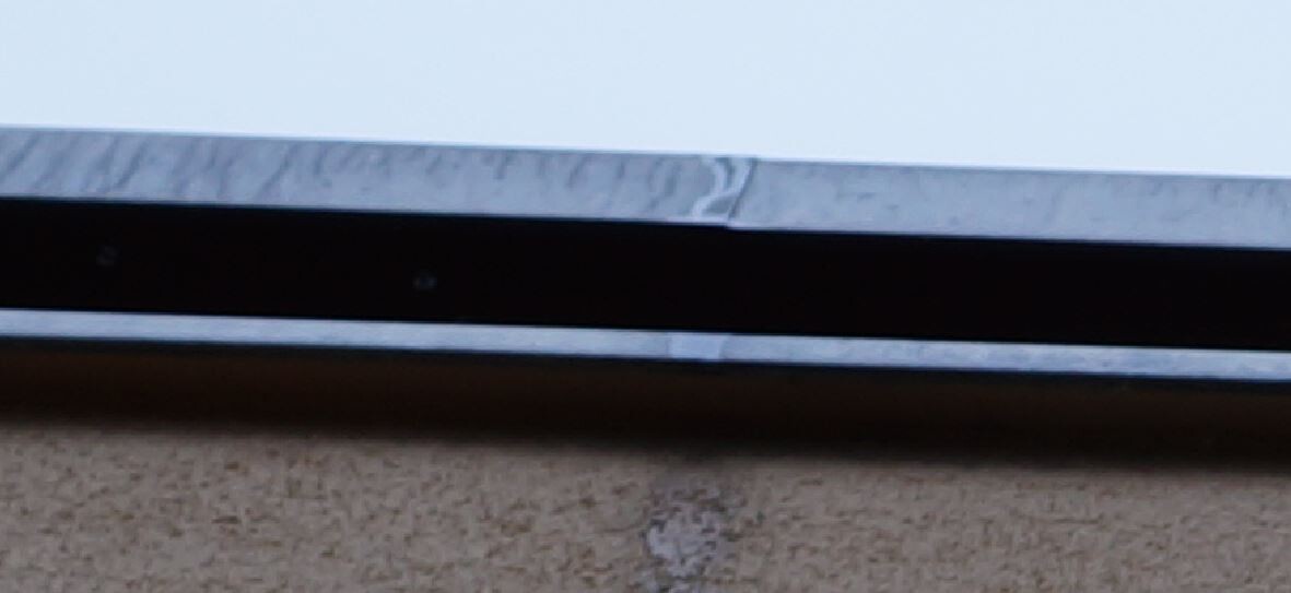 Close-up of a metallic window frame profile on an exterior wall