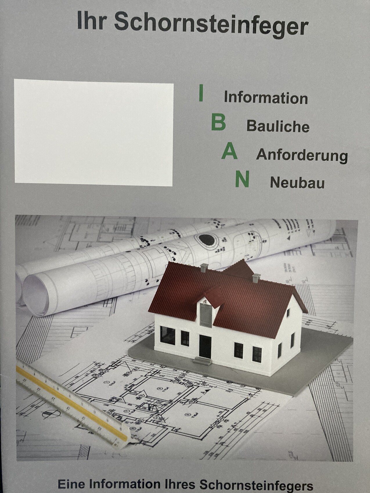 Miniature house model lying on blueprints and plans, symbolizing house building planning