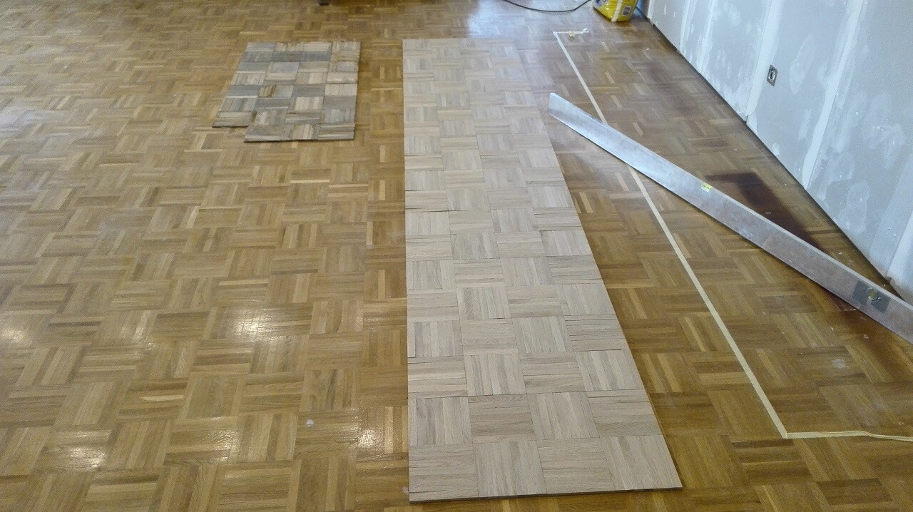 Renovated interior with installed hardwood flooring and tools on the floor