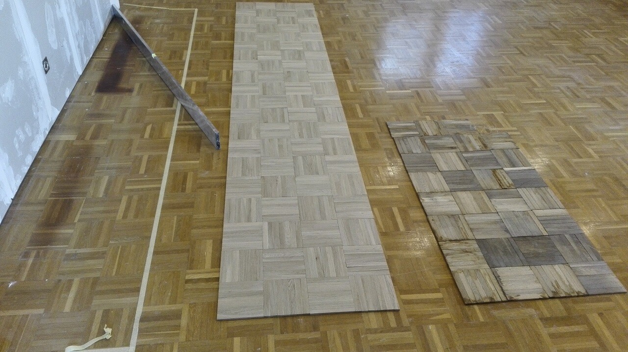 Parquet and mosaic flooring on a wooden floor, renovation works visible.