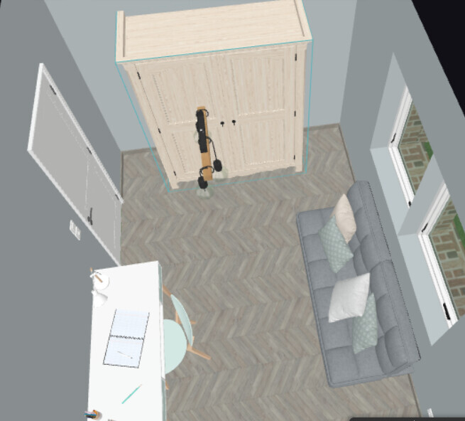 Bird’s-eye view of a room: sofa on right, cabinet in center, guitar in front, desk on left.