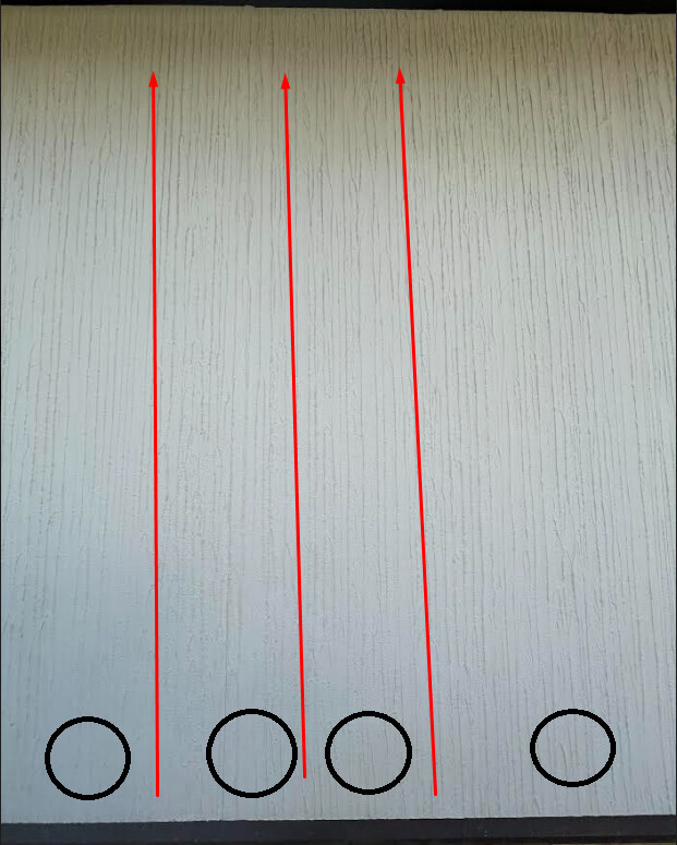 Four red arrows rising from four black circles on the ground towards a bright wall.