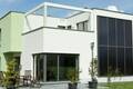 Exterior view of a modern single-family house with glass facade