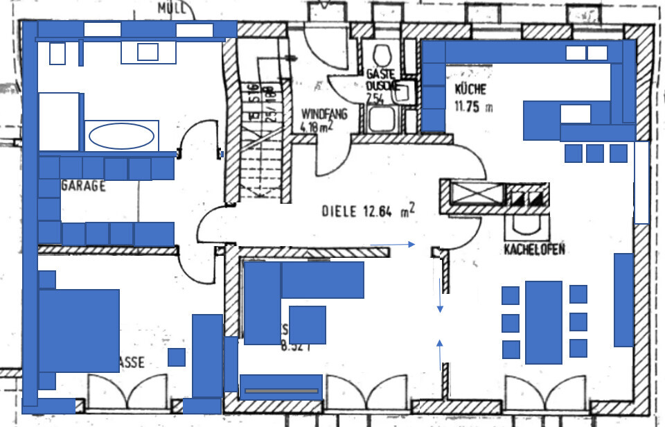 Floor plan of a house with garage, hallway, kitchen, guest shower, and tiled stove.