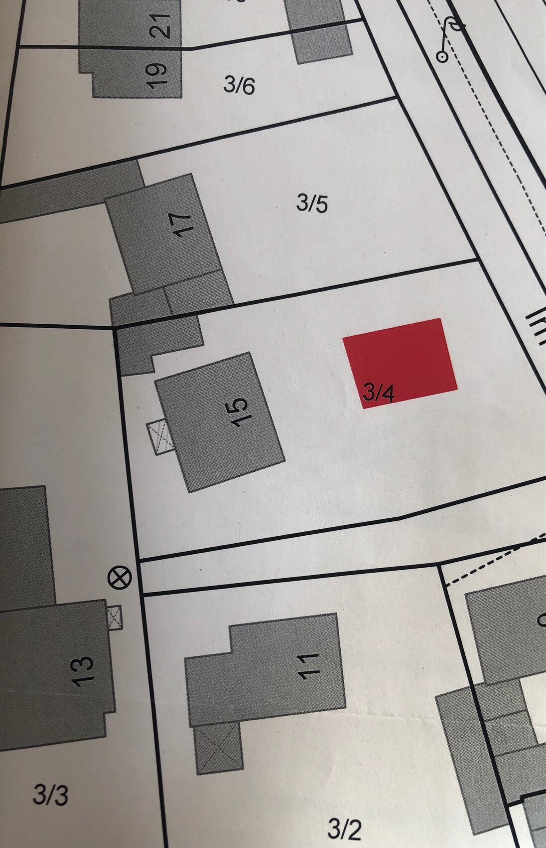 Site plan: red square marks 3/4, surrounded by buildings and roads.