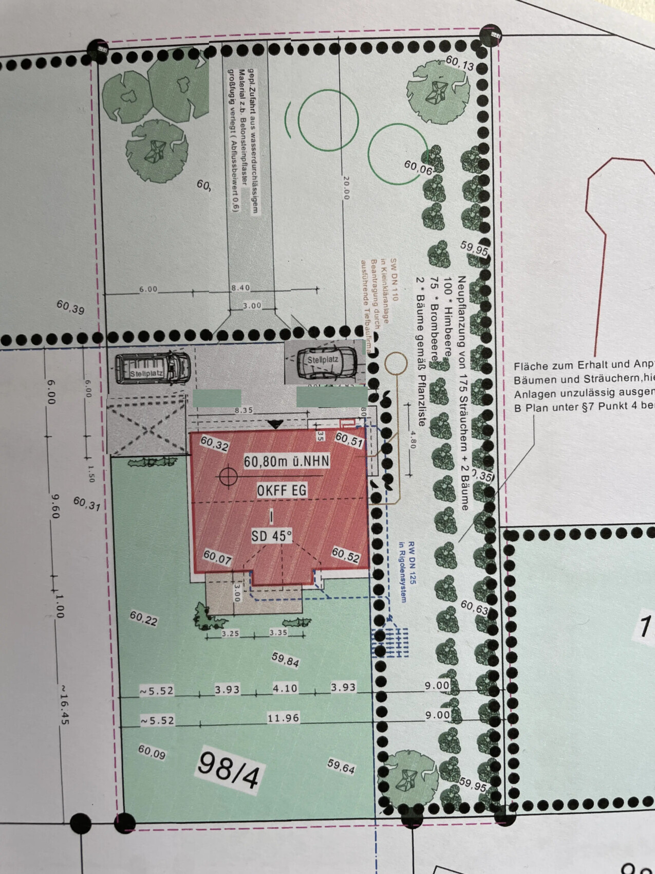 Site plan of a plot: red house with parking spaces, rows of trees, and boundary lines.