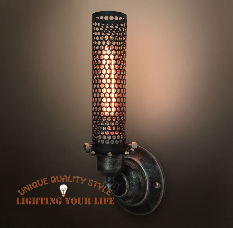 Industrial wall lamp with perforated metal shade and warm bulb light