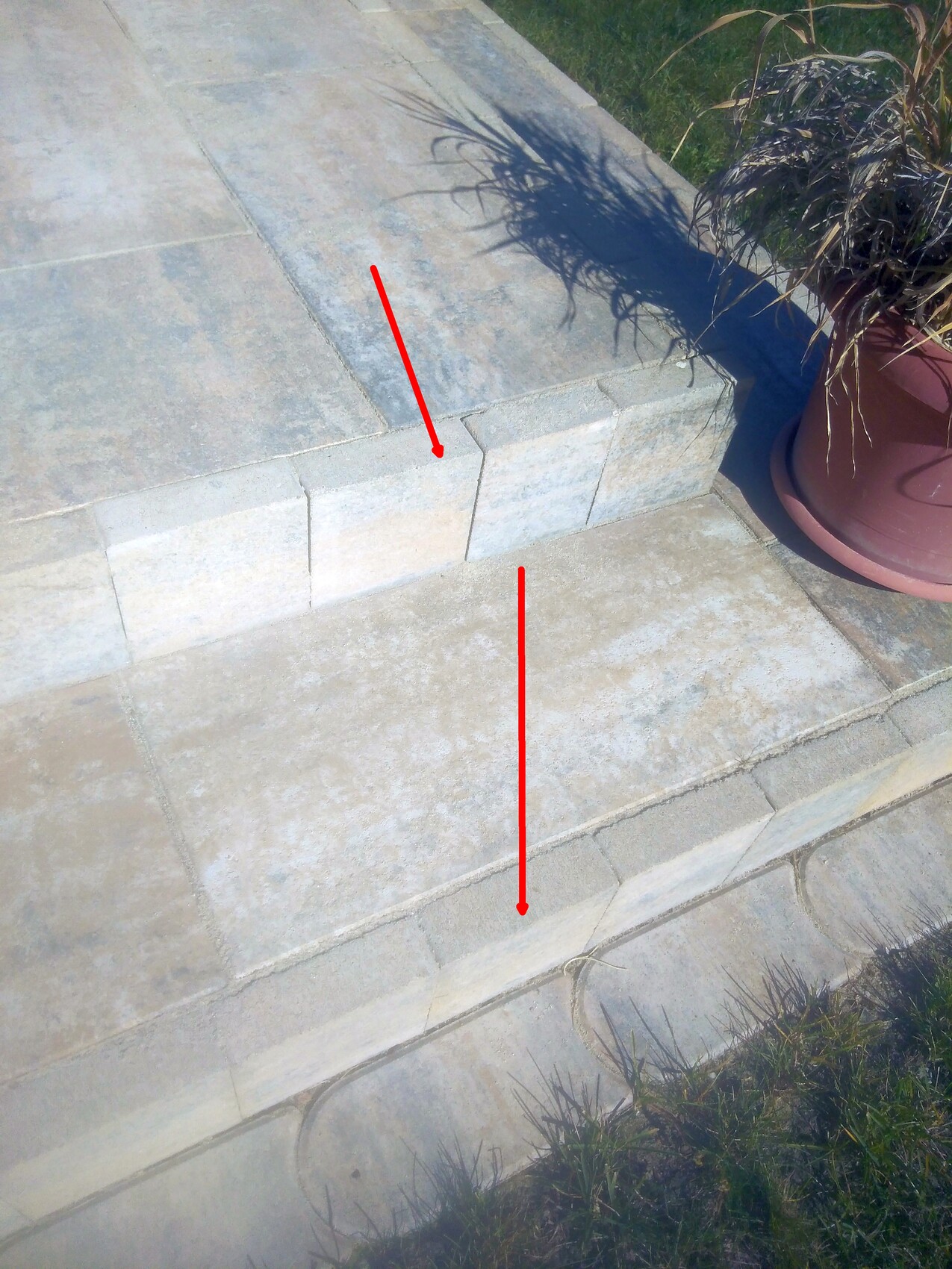 Outdoor area with light gray stone steps, planter on the right; red lines mark edges.