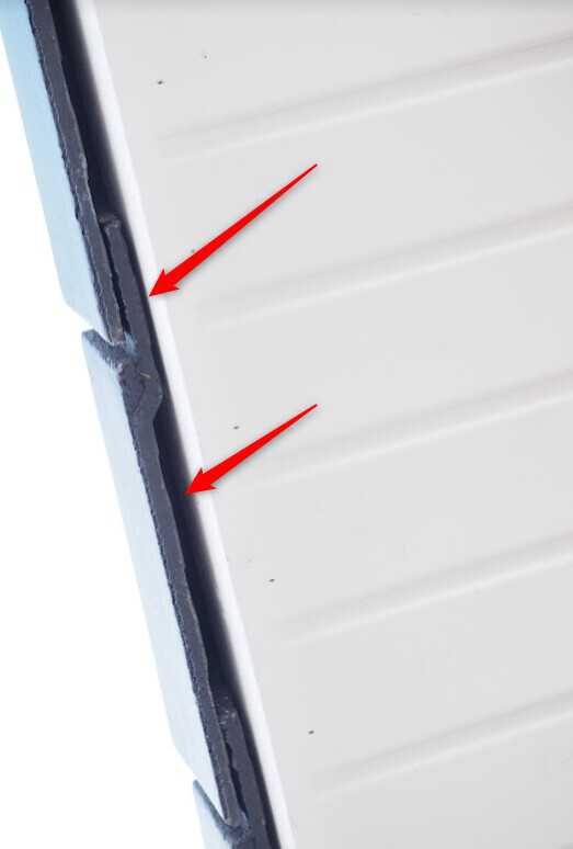 Close-up of a white, ribbed door leaf with a blue edge; gaps visible