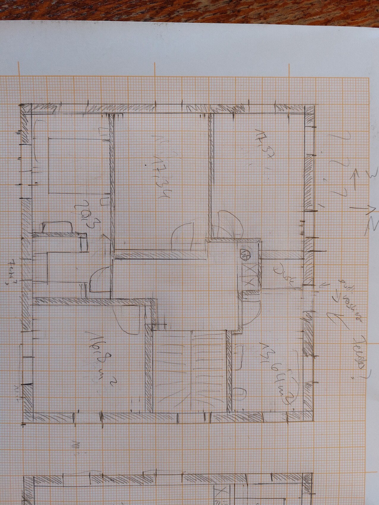 Hand-drawn floor plan of a building on graph paper: several rooms, doors, and walls.
