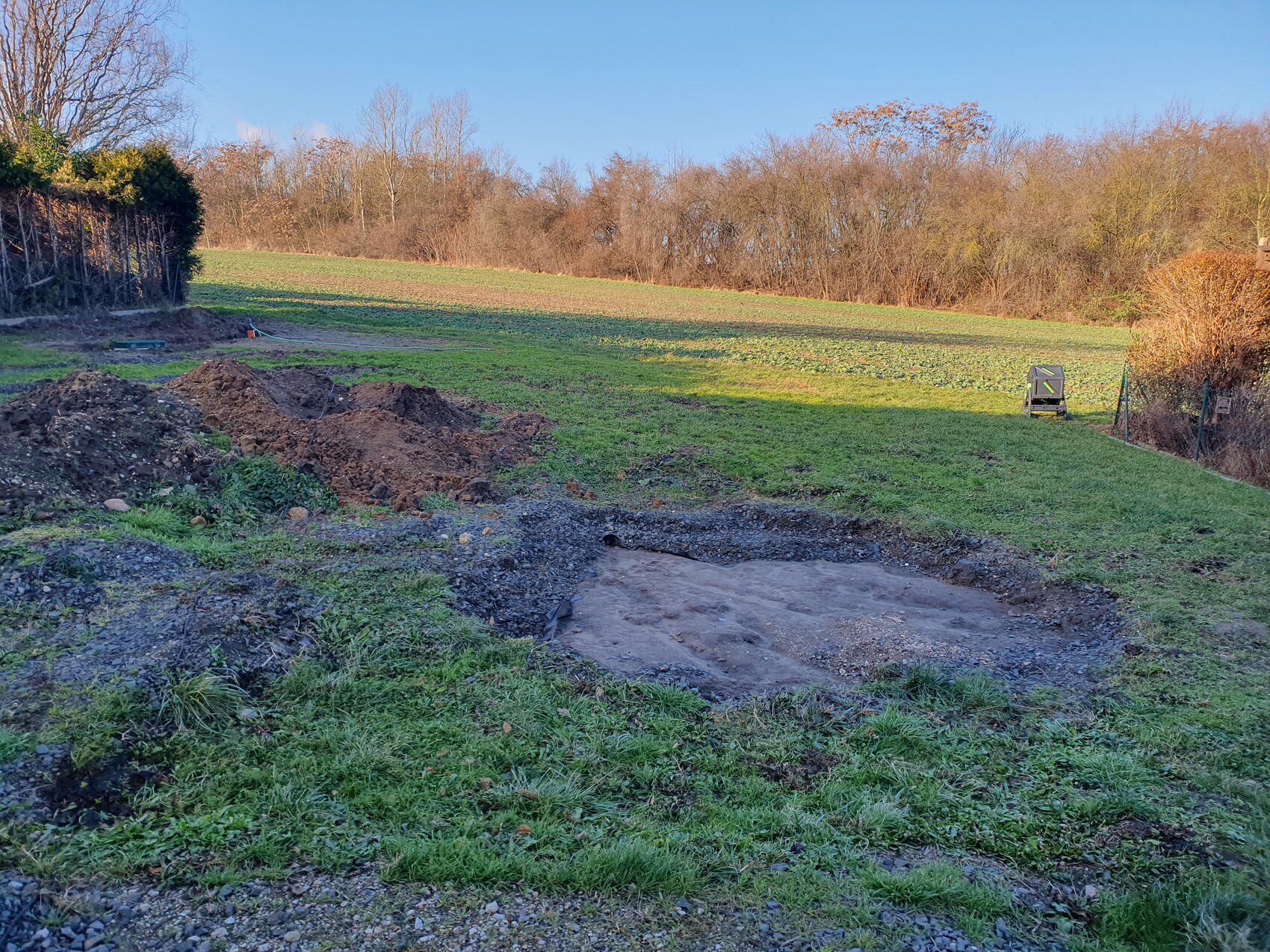 Excavation of strip foundation on open farmland; earthworks in the building ground
