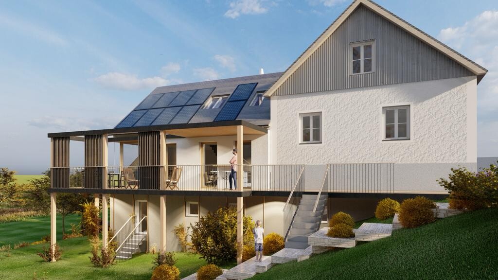 Modern house with solar panels on the roof, a large terrace, and a garden