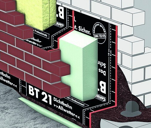 Cross-section of an exterior wall with brick veneer, green insulation, and black waterproofing membrane.